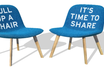 Two chairs facing each other, on one chair it says pull up a chair on the other it says its time to share